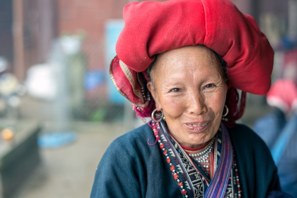 Red Dao woman in a village outside Sa Pa –  famous for its rugged scenery and its rich cultural diversity.