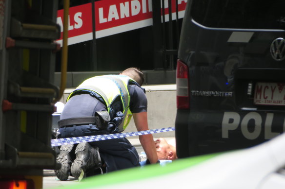 A police officer talks with Gargasoulas after the rampage.