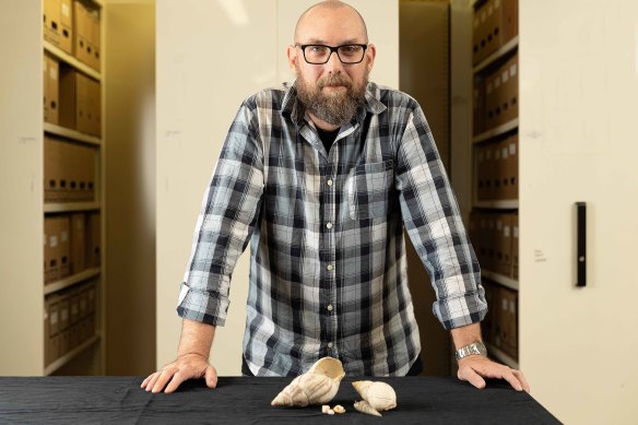 Dr Patrick Faulkner with some examples of African land snail shells.