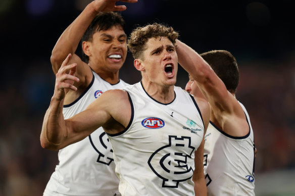 Charlie Curnow celebrates a late goal with teammates.