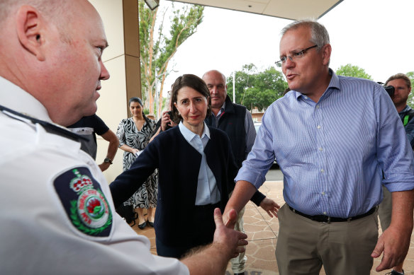 Prime Minister Scott Morrison and NSW Premier Gladys Berejiklian with RFS Commissioner Shane Fitzsimmons arriving on Sunday at the Picton Bowling Club, which is being used as a evacuation centre.