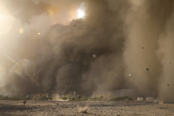 Debris flies from the direction of the launch pad as SpaceX’s Starship launches from Starbase in Boca Chica, Texas, on April 20. 