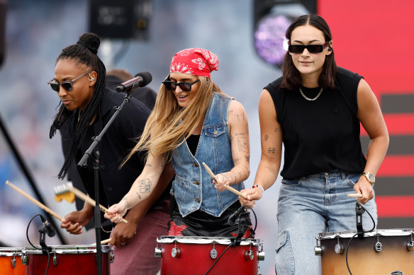 G Flip performs with support from cameo drummers Sabrina Frederick of Collingwood and Jesse Wardlaw of St Kilda during the 2023 AFLW grand final match pre-match entertainment.