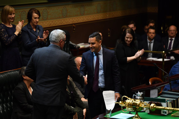 NSW Health Minister Brad Hazzard congratulates Member for Sydney Alex Greenwich as he introduces the Reproductive Healthcare Reform Bill 2019 in the Legislative Assembly at NSW Parliament House on Thursday.