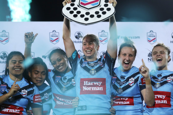 New South Wales captain Keze Apps raises the Shield after last year's Women's State of Origin.