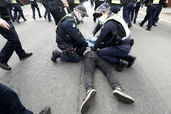 A man is arrested in Melbourne during a 2021 anti-lockdown protest.