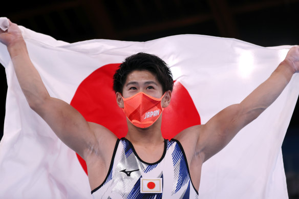 Daiki Hashimoto celebrates his victory with the Japan Flag during the men’s all-around Final on day five of the Tokyo Olympics.