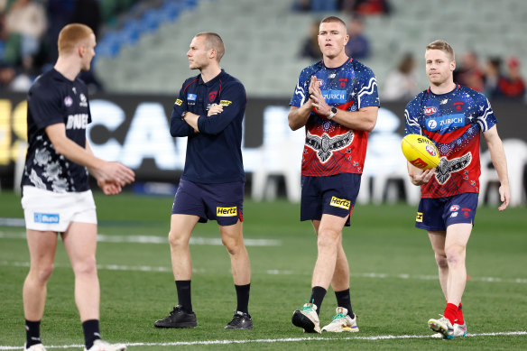 Melbourne players warming up ahead of semi-final clash with Carlton.