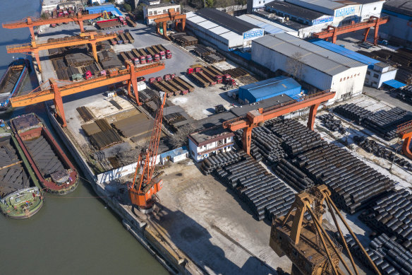 Barges sit docked at a steel stockyard in this aerial photograph in Shanghai on Monday.
