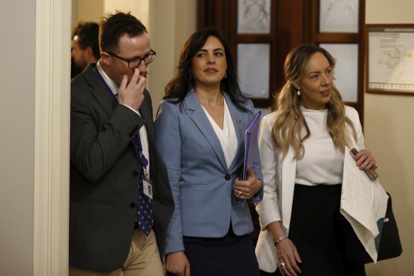 Moira Deeming enters the party room meeting with colleagues Joe McCracken and Renee Heath.