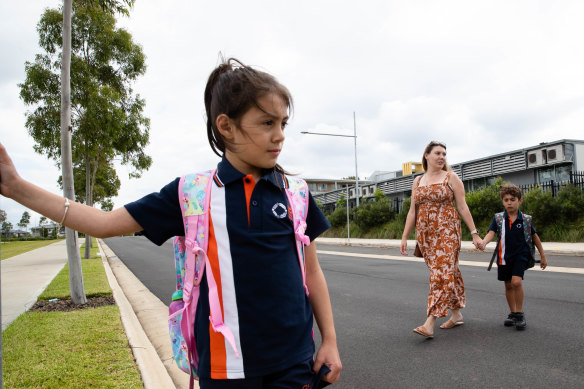 Hanna Braga with her children Aliyah and Ben in front of the demountables at Gledswood Hills Public School.