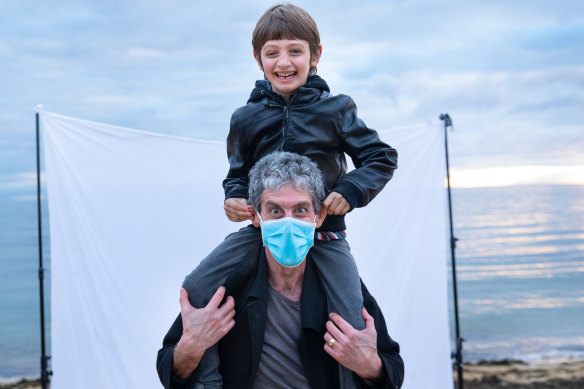 Associate Professor Daryl Efron flashes a big smile through his mask with seven-year-old son Luca.