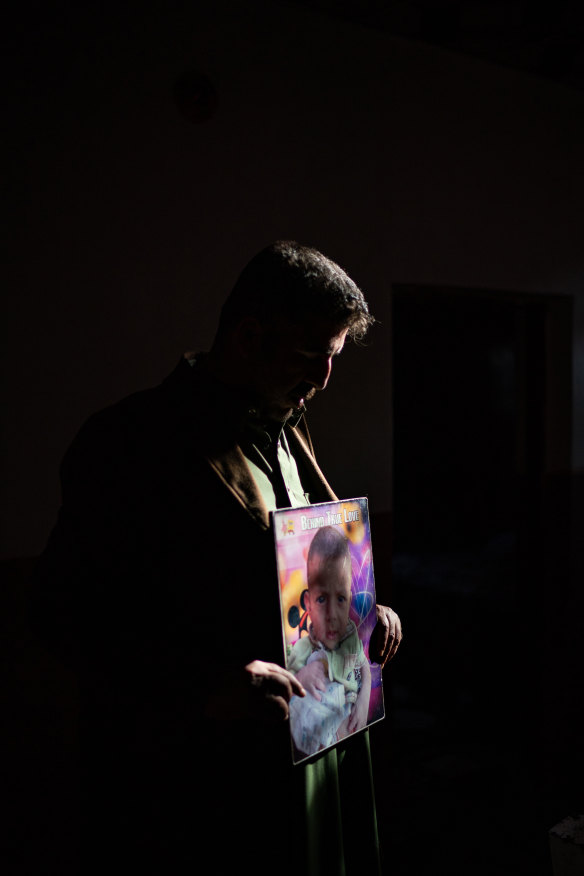 Tamim Ahmed al-Tamimi, 35, holds a photo of his two-year-old son, Mehdi, on February 23. His son died after being exposed to smoke from the burn pit at Joint Base Balad in Iraq. 
