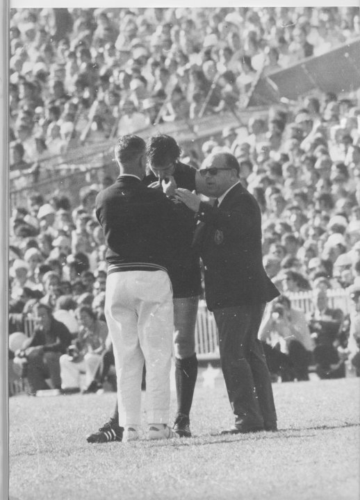 Carlton’s Geoff Southby speaks to a trainer and a doctor after he was felled by Balme.