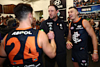 Nic Newman and Patrick Cripps congratulate Josh Fraser after a win.