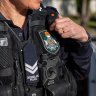 Qld police officer struck over head with glass bottle, two charged