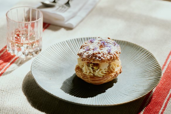 Paris brest with hazelnut mousseline, poached pear and candied mandarin.