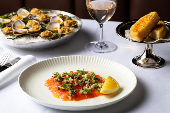 Clockwise from top left: Clams casino, crumpets and Ora King salmon gravalax at Bistro George in Sydney. 