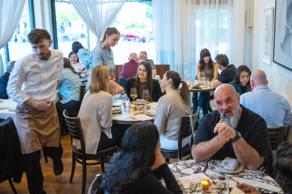 White tablecloths and bistro curtains add a timeless quality to the Victorian-era shopfront.