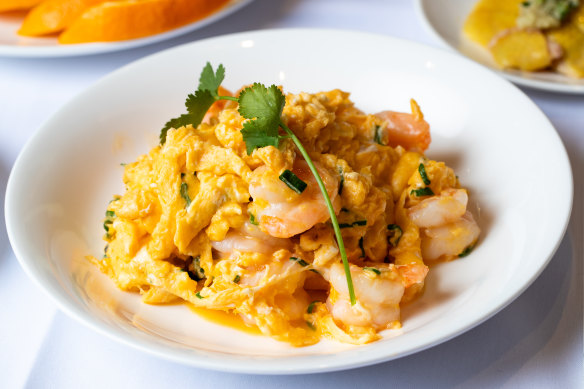Light and fluffy prawn scrambled eggs is studded with almost translucent steamed prawns.