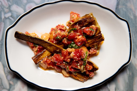 Artichoke finished on the grill and bathed in a vibrant sauce of fresh tomatoes and pesto Trapanese (basil, olive oil and almonds). 