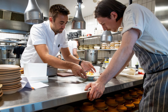 Executive chef Oliver Marlow (left) prepares a L’Enclume dish in the  Bathers Pavilion kitchen.