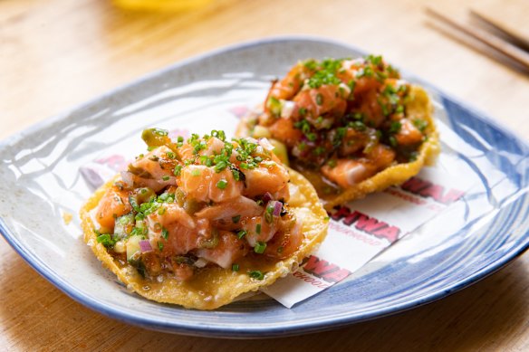 Salmon tostadas atop crisp wonton wrappers.