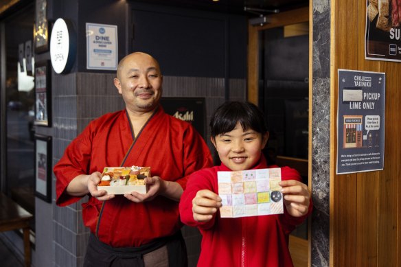 Chef Tomoyuki Matsuya pictured with his daughter Mone (and her drawing) in 2021.