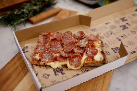 Salami pizza slice.