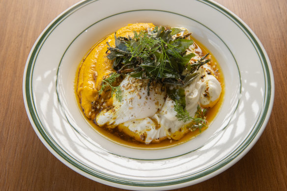 Vadouvan eggs: Poached eggs drizzled with spiced ghee and garnished with zaatar over herbed carrot puree and lemon labne.