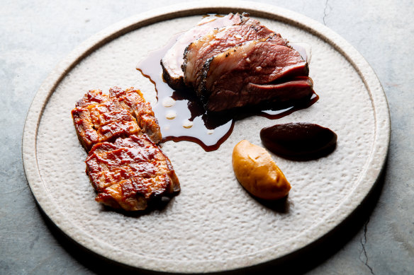 Roasted Margra lamb rump is served with crisped belly, pumpkin miso and black garlic.