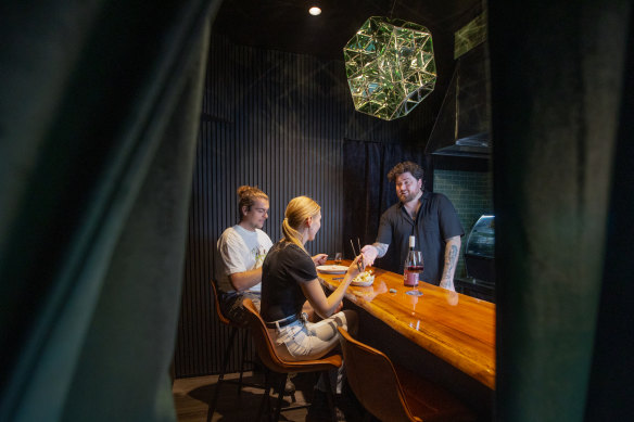 Emerald City chef Joel Alderdice behind the counter of his four-seat restaurant.