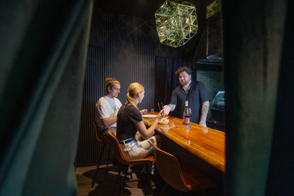 Emerald City chef Joel Alderdice behind the counter of his four-seat restaurant.