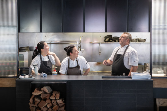 Chef Steven Nelson and team in the open kitchen, which is now partially screened.