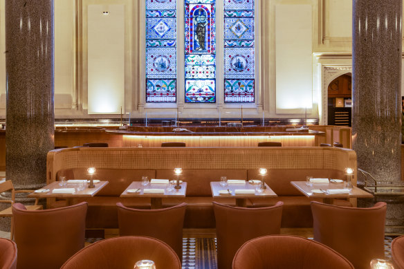 Tan leather and perforated timber booths help divide the grand dining room.