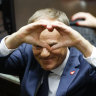 Donald Tusk shows a heart with his hands to lawmakers after he was elected as Poland’s Prime Minister in parliament in Warsaw on Monday.