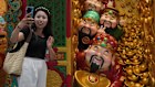 A woman takes a selfie with gods of fortune displayed outside a store selling prosperity items at a shopping mall, in Beijing. Household spending remains weak.