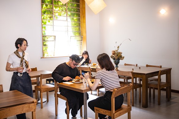 Cham is kitted out with chunky timber chairs and stainless steel tables fabricated in Ho Chi Minh City.