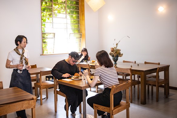 Cham is kitted out with chunky timber chairs and stainless steel tables fabricated in Ho Chi Minh City.