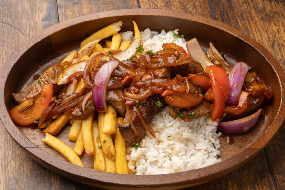 Lomo saltado, a Peruvian beef stir-fry, served with chips and rice.