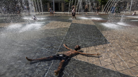 Kais Bothe relaxes in the cool in the city hall pool, as temperatures hit 37 degrees in Edmonton, Alberta, on Wednesday.