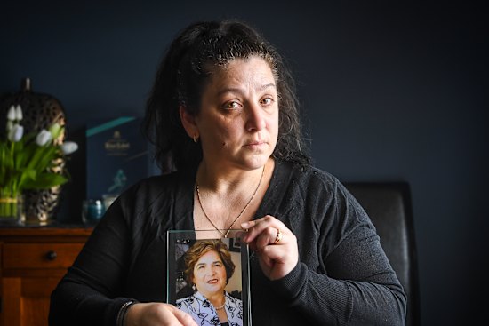 Klery Loutas, holding a photo of her mother Filia Xynidakis.
