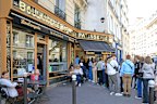 Visitors queue at a patisserie in Paris featured on the Netflix series Emily in Paris.