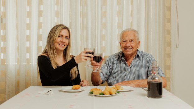 Jessica Timpano and her nonno, Bart Nicoliello, enjoy home-made croquettes and wine.