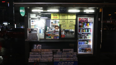 A newsstand vendor wears a mask to prevent catching coronavirus in Seoul, South Korea. 