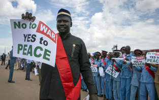 South Sudanese people hold peace signs as talks to end the five-year civil war got under way in June.