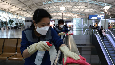 Cleaners spray disinfectant at Seoul's Incheon Airport.  The coronavirus outbreak has dented travel demand in the Asia Pacific. 
