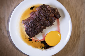 He eats vegetarian at home, so time to order hanger steak, with burnt garlic and egg yolk sauce. 