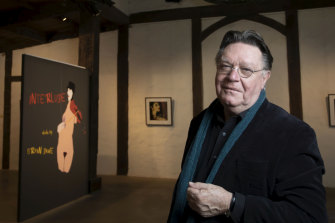 Bryan Dawe with his current exhibition at Montsalvat's Barn Gallery. 