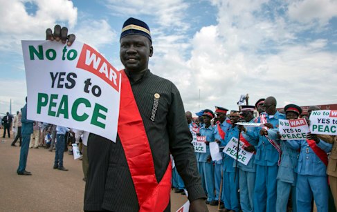 South Sudanese people hold peace signs as talks to end the five-year civil war got under way in June.